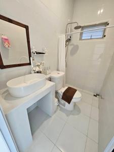 a white bathroom with a sink and a toilet at Treat Boutique HuaHin 94 in Hua Hin +45 photos