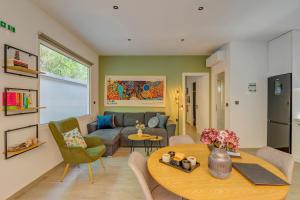 a living room with a table and a couch at Kalafatis Garden House in Itea