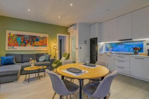 a living room with a couch and a table with chairs at Kalafatis Garden House in Itea +64 photos