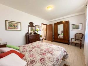 a bedroom with a large bed and a dresser and a chair at La Sosta di Braccio in Macchie