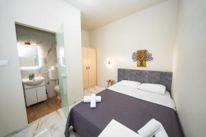 a small bedroom with a bed and a bathroom at Penelope - Sea Front Studio in Gouvia