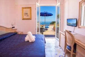 a bedroom with a bed and a view of the ocean at Hotel Terme Cristallo Palace in Casamicciola Terme +52 photos