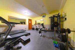 a gym with several treadmills and machines in a room at Hotel Terme Cristallo Palace in Casamicciola Terme