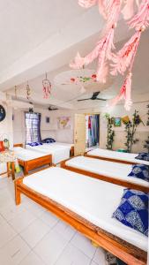 a bedroom with three beds in a room at Backpackers Hub in Dimapur