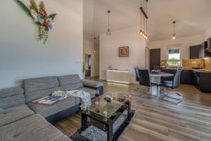 a living room with a couch and a table at Apartments Doris in Malinska