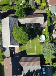 an overhead view of a house with a tennis court at Zur Alten Post in Großkoschen