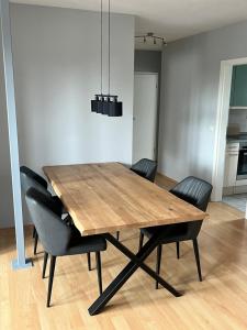 a dining room with a wooden table and chairs at Wohnung Ton Strand in Fehmarn