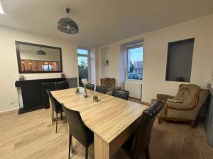 a living room with a wooden table and chairs at Maison de maître in Bressuire +5 photos