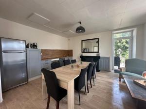 a kitchen and dining room with a table and chairs at Maison de maître in Bressuire