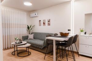 a living room with a couch and a table at Lighthouse Nest AXD in Alexandroupoli