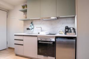 a kitchen with a stove and a sink at Lighthouse Nest AXD in Alexandroupoli