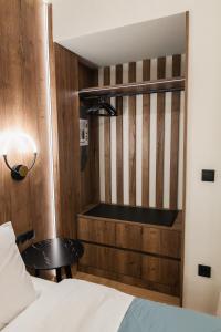 a bedroom with a bed and a table in a room at Lighthouse Nest AXD in Alexandroupoli