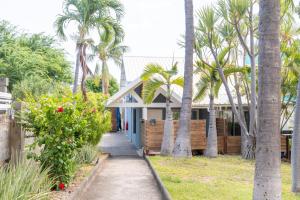 a house with palm trees in front of it at Ilot Bleu in Boucan Canot