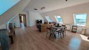 a large living room with a table and chairs at Idyllische Ferienwohnung im Kalletal in Kalletal