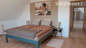 a large bed in a bedroom with a mirror at Idyllische Ferienwohnung im Kalletal in Kalletal