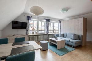 a living room with a couch and a table at Nordsee-Apartments Hinrichsen in Husum