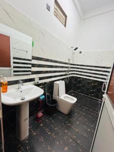 a bathroom with a sink and a toilet at Wake N Flow, Arugam Bay in Arugam Bay +24 photos