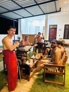 a group of men sitting at tables in a restaurant at Wake N Flow, Arugam Bay in Arugam Bay
