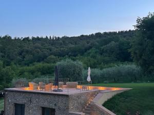 a house with a patio with chairs and lights at Podere Casanuova in San Gimignano +147 photos