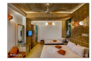 ein Hotelzimmer mit zwei Betten und einem Fernseher in der Unterkunft Hotel Beach Way in Cox's Bazar + 53 Fotos