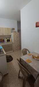 a kitchen with a table and chairs in a kitchen at Cockpit in Le Kram