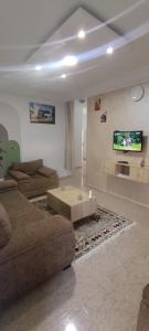 a living room with a couch and a tv at Cockpit in Le Kram +5 photos