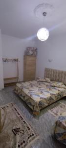 a bedroom with a bed and a dresser in it at Cockpit in Le Kram