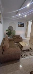 a living room with a teddy bear sitting on a couch at Cockpit in Le Kram