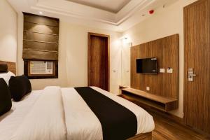 a bedroom with a bed and a tv on a wall at Collection O Stargaze in Kānpur +18 photos