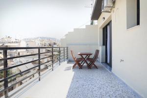 a balcony with a table and chairs on a building at Urban Liv Athens in Athens