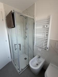 a bathroom with a shower and a toilet and a sink at Attico Terracotta in Borgo Bainsizza +22 photos