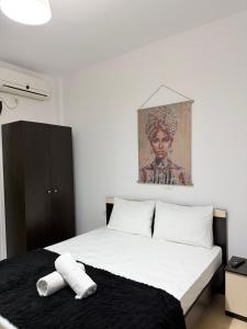 a bedroom with a bed with two towels on it at Apartments Gigu in Ksamil