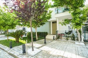 a house with trees in front of it at Blue Coast - Villa 1 Perla Resort in Lalëz