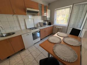 a kitchen with a table with plates on it at Sweet Home in Ocna-Mureşului