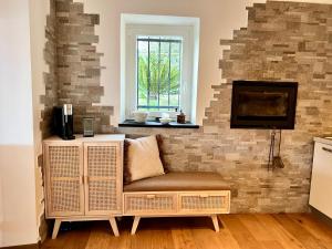 a living room with a chair and a tv at Da Ö NOXE in Bracco +7 photos