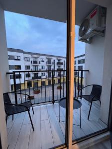 a balcony with chairs and a view of a building at Apartament Raj in Biała Podlaska