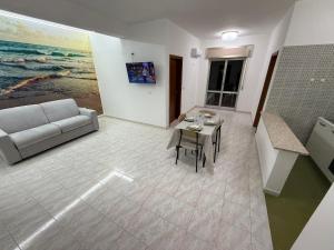 a living room with a couch and a table at SeaMood Casa Vacanze in Praia a Mare