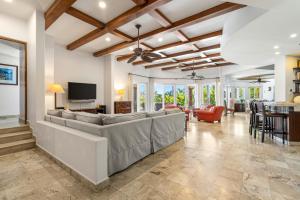a living room with a large couch and a television at Palmilla Golf and Beach Villa in San José del Cabo