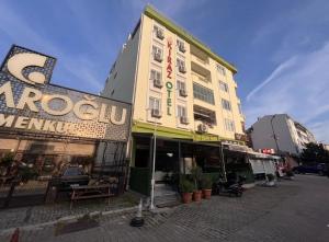 a building with a sign on the side of a street at Kiraz Otel in Lapseki