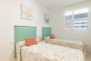 a bedroom with two beds and a window at Horus 054 in Torre del Mar +17 photos