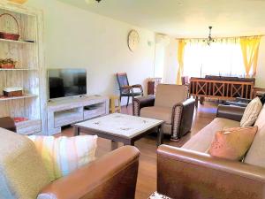 a living room filled with furniture and a flat screen tv at Ilidza Holiday Home in Sarajevo