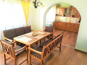a dining room with a wooden table and chairs at Ilidza Holiday Home in Sarajevo
