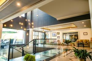 a lobby with a staircase in a building at City Hotel in Abbottabad