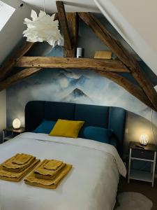 a bedroom with a blue bed with towels on it at Villa Ô Bedroom2 studio entier in Chasnay +20 photos