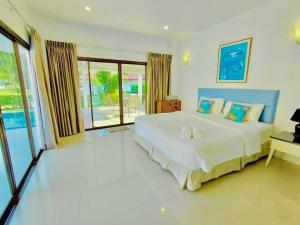 a bedroom with a large bed and a large window at Baan Golden Pool Villa in Sam Roi Yot +111 photos