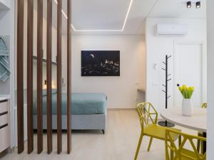 a bedroom with a bed and a table with a yellow chair at B&B CASA VACANZA ETHOS il POSTO DA VIVERE in Casa Boscarelli +38 photos