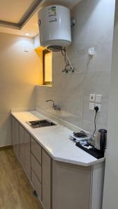 a kitchen with a sink and a counter top at شقق تاج اليرموك الفندقية in Tabuk