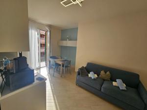 a living room with a couch and a table at Beach and Bike e Beach and Sun in San Lorenzo al Mare