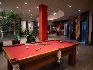 a pool table in the middle of a room at ibis Caxias do Sul in Caxias do Sul