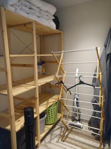 a shelf in a room with a bed at Klauwaards appartement in Kortrijk